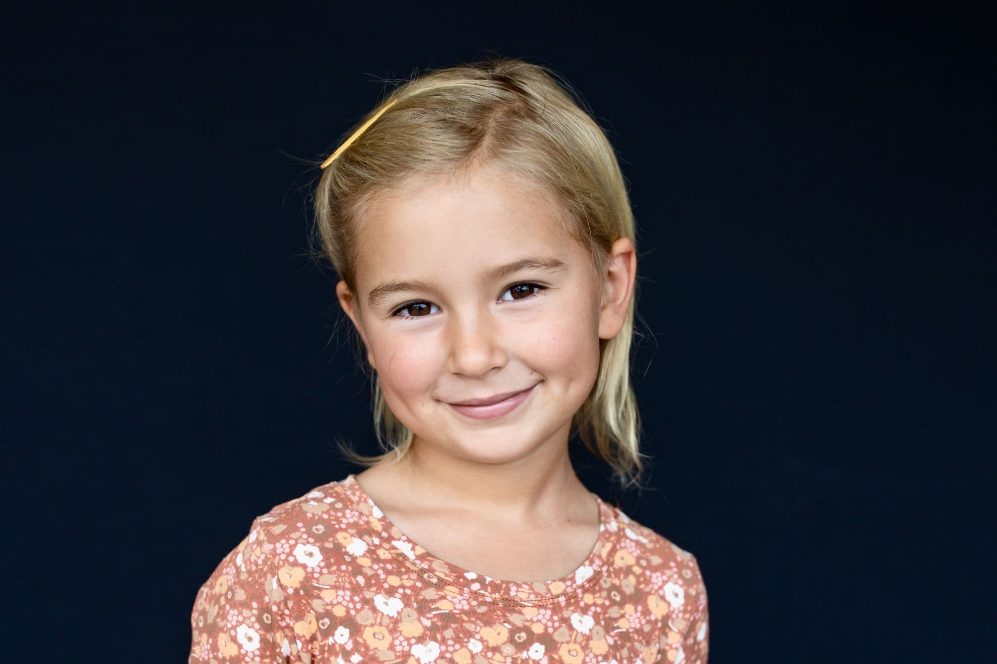 San Francisco elementary school portrait of blonde girl in coral floral print top