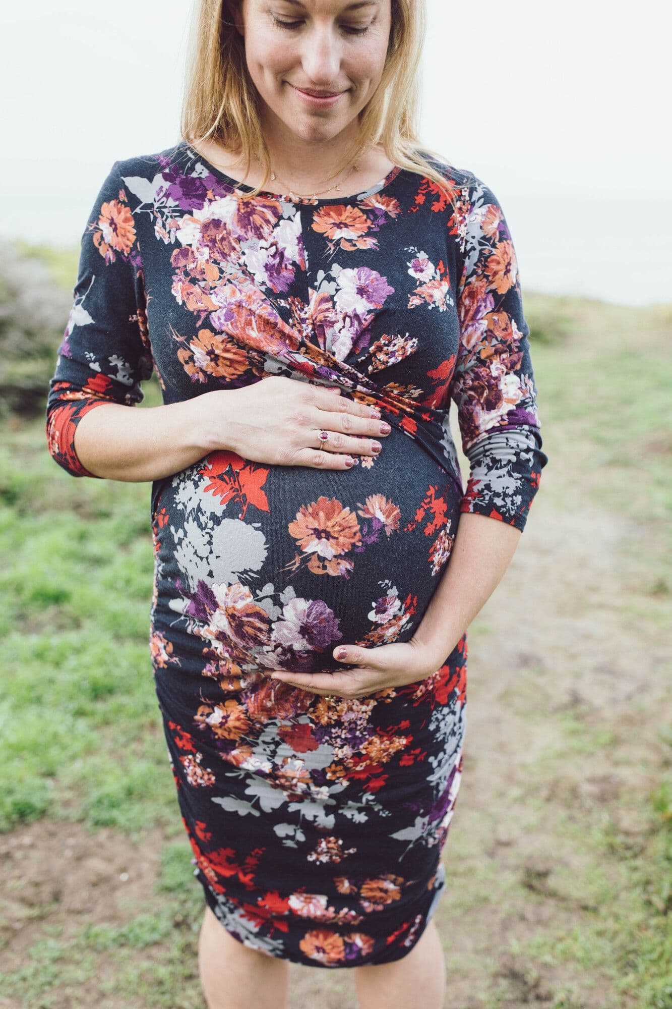 Pregnant woman in dark floral dress during San Francisco maternity session