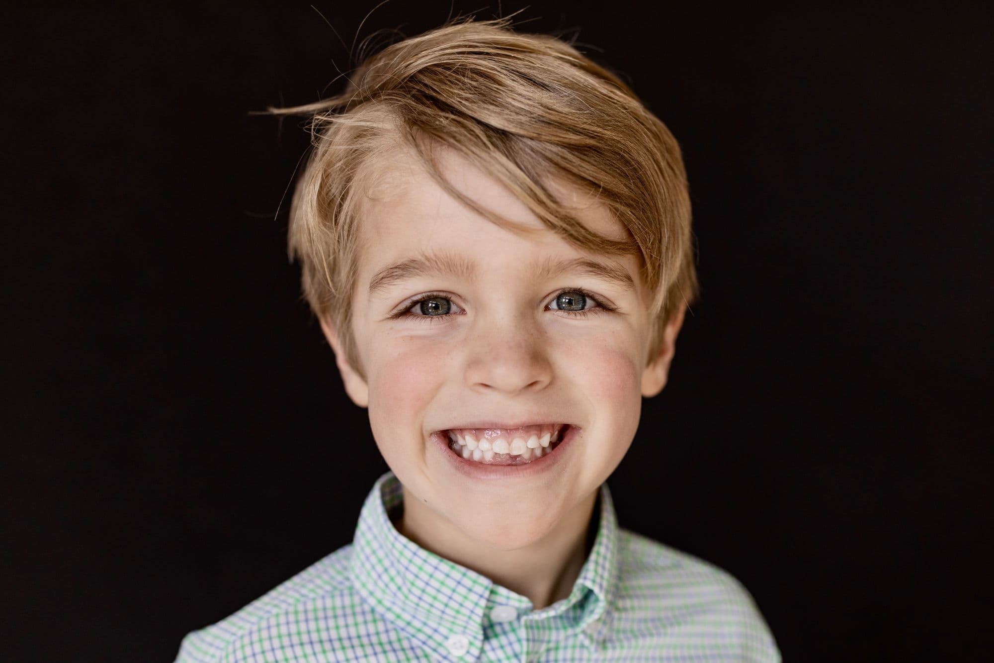 San Francisco school portrait of young boy with brown hair wearing navy blue crew neck sweater