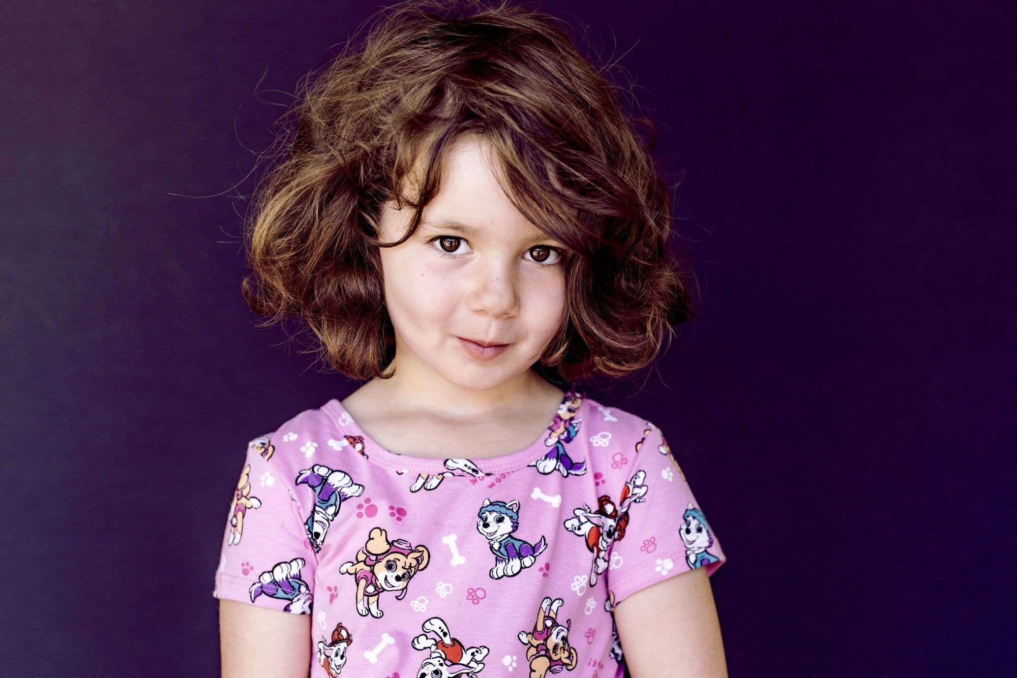 Professional San Francisco school photo of young girl wearing pink Paw Patrol character shirt