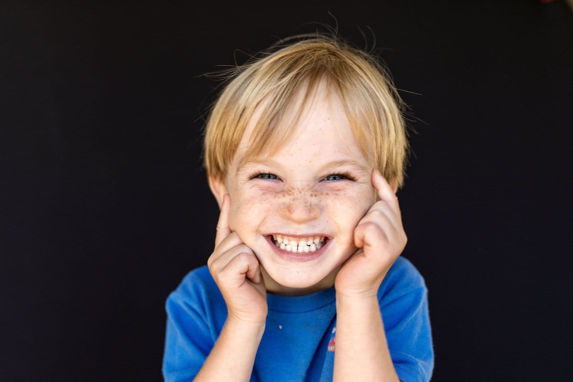San Francisco elementary school portrait of blonde boy with freckles in bright blue shirt