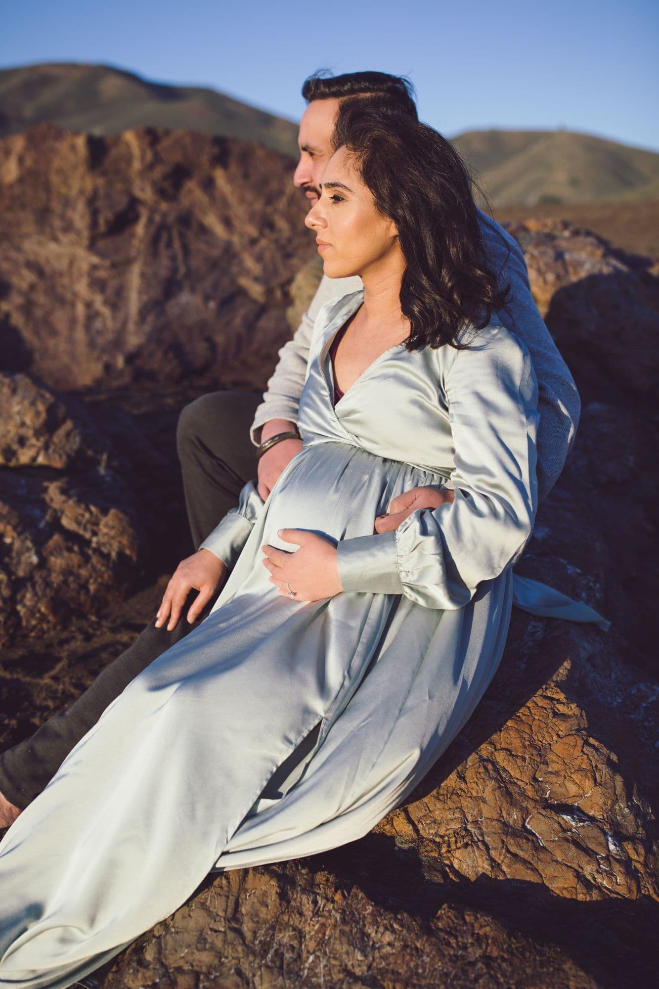 Expecting couple embracing outdoors by San Francisco maternity photographer