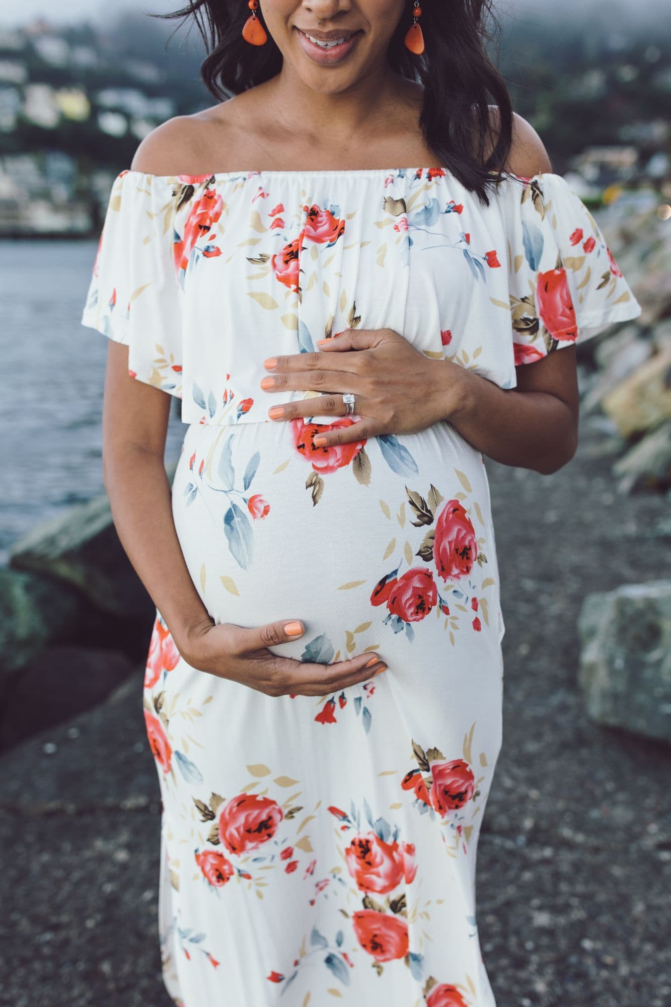 Pregnant woman in off-shoulder white floral dress by San Francisco photographer