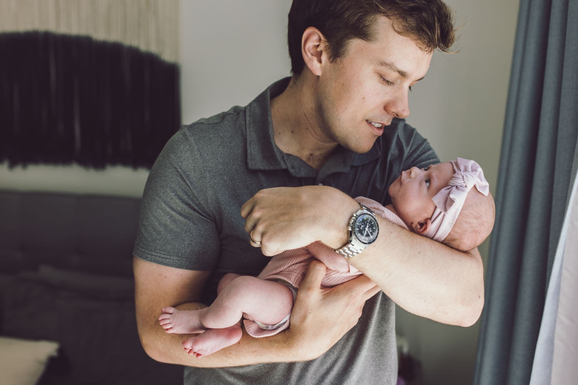 Father holding newborn baby during San Francisco lifestyle photography session