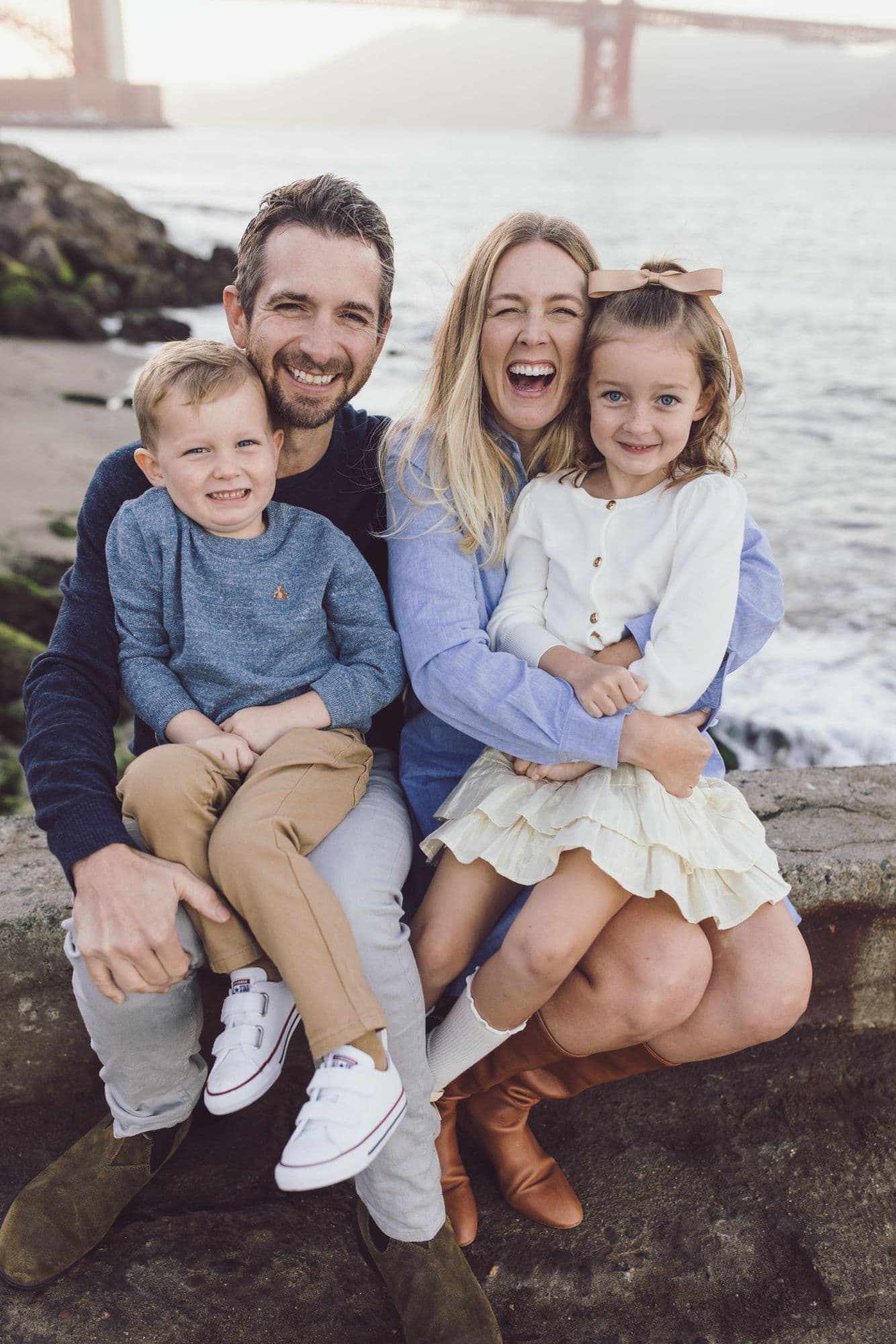 Family portrait on the beach in San Francisco with the Golden Gate Bridge in the background