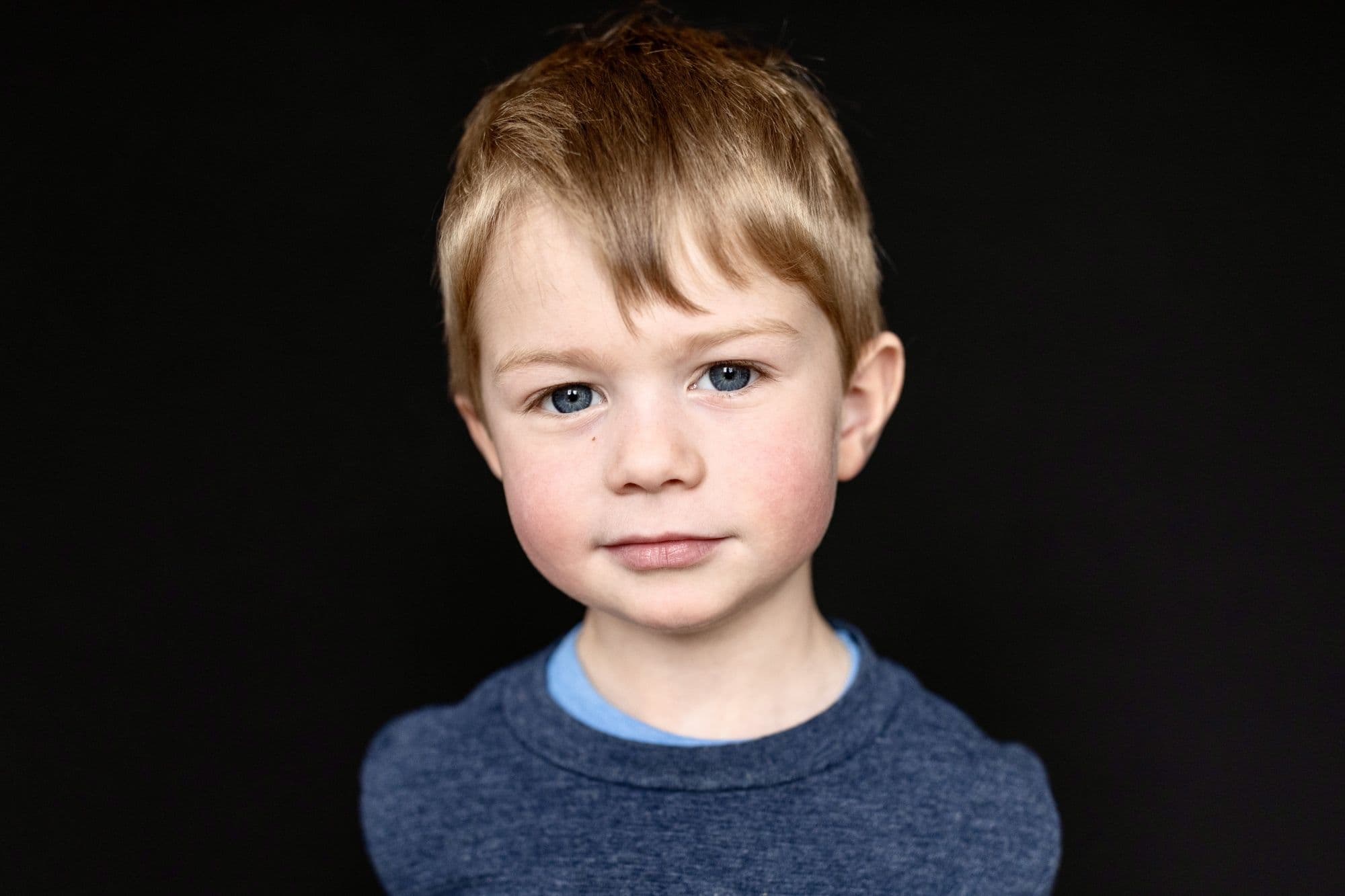 San Francisco school portrait of blonde boy wearing navy blue crew neck sweater