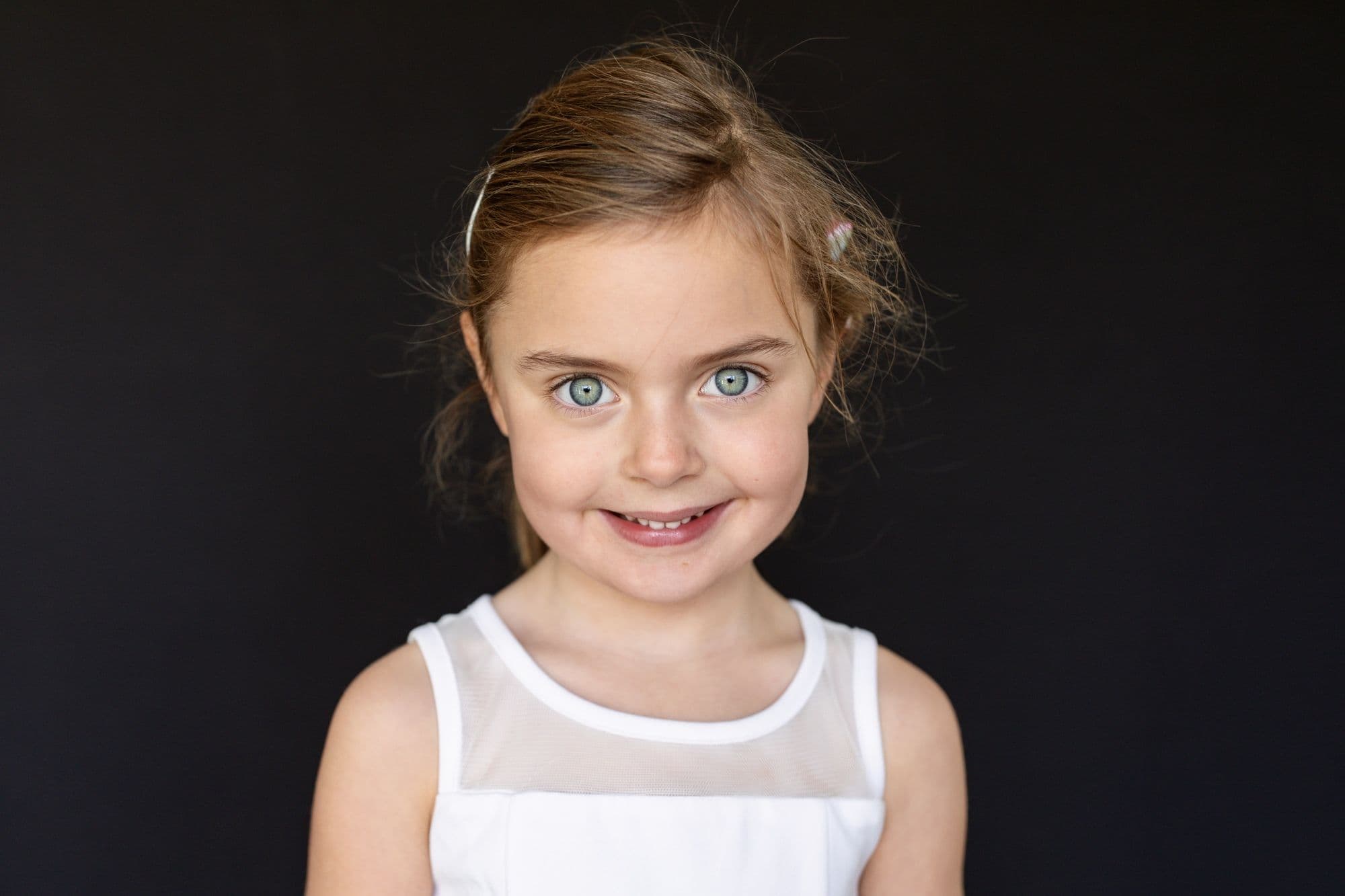 San Francisco school photographer captures elementary student in white tank top with striking blue eyes