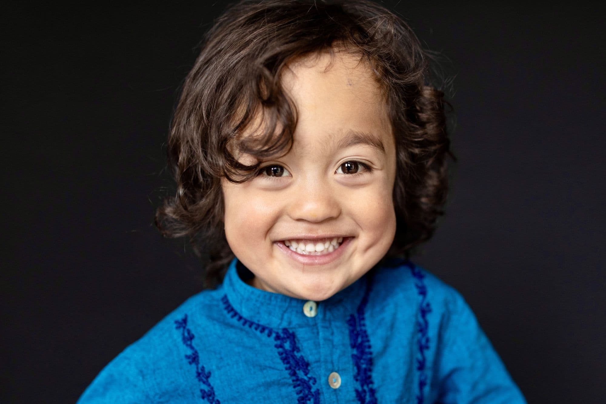 Professional San Francisco school portrait of young student in traditional blue embroidered shirt