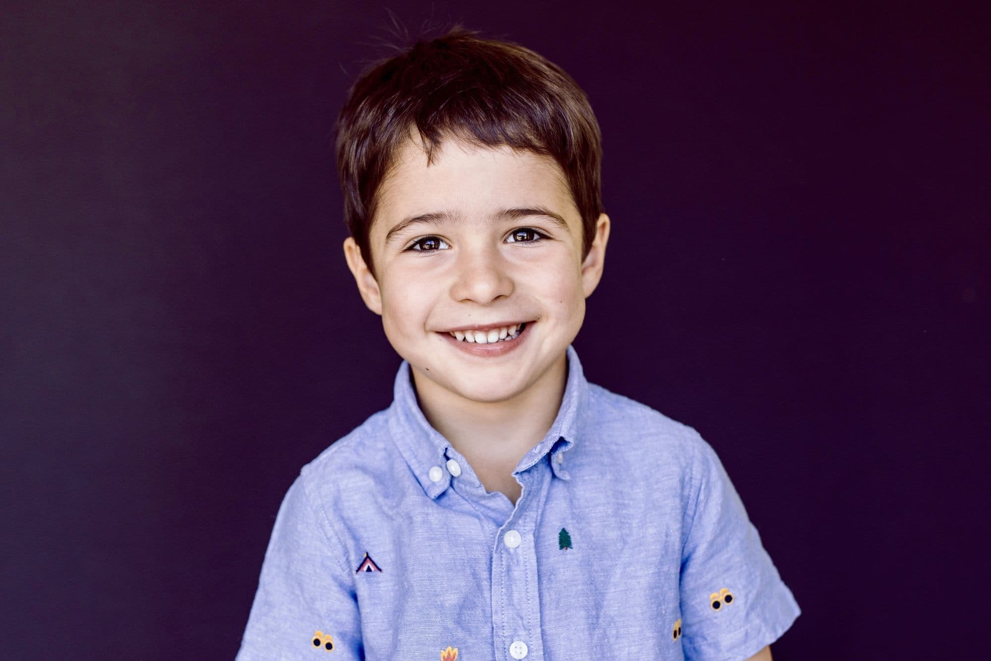 San Francisco school photographer captures young boy in cozy bear-themed knit sweater portrait